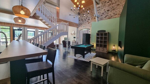 A spacious living area with a pool table, a staircase, and a billiards table. - Gîte le Quai (8 people) (Champagnac-la-Rivière)