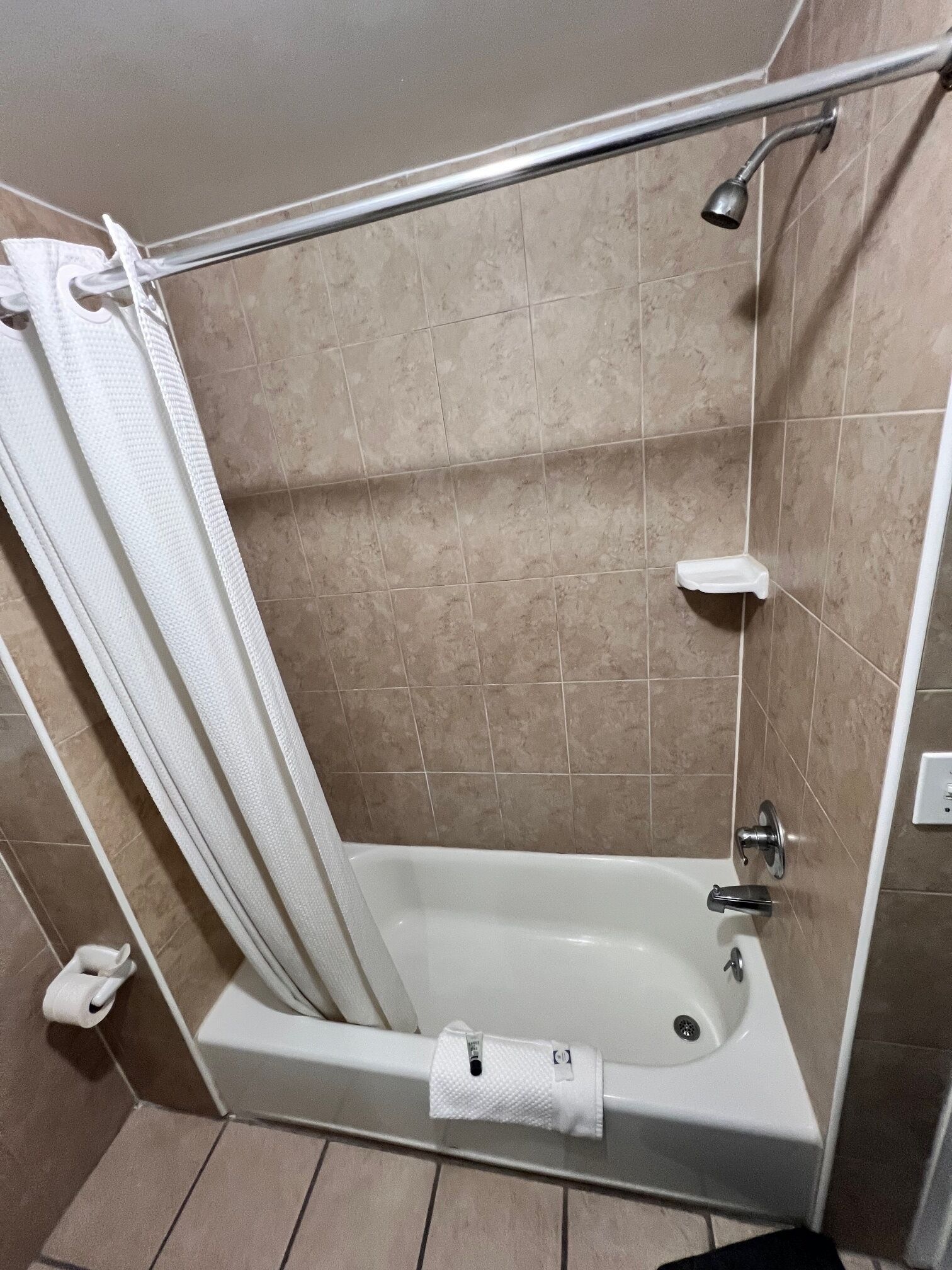 A bathroom with a bathtub, a shower, and a toilet.