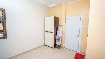 Une pièce avec une armoire, une porte et un miroir.