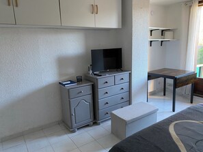 Tabla de planchar con plancha y ropa de cama