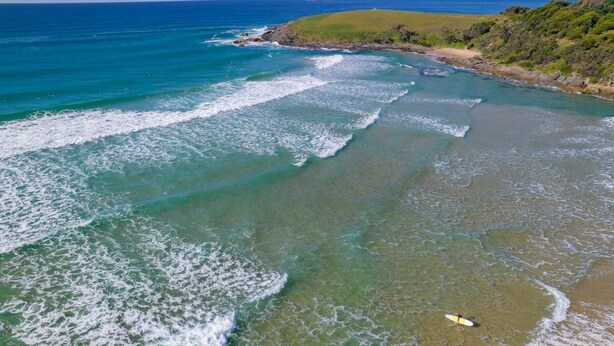 A coastal area with clear waters, a sandy beach, and a grassy hill. - Moonee Beach Getaway - (Moonee Beach)