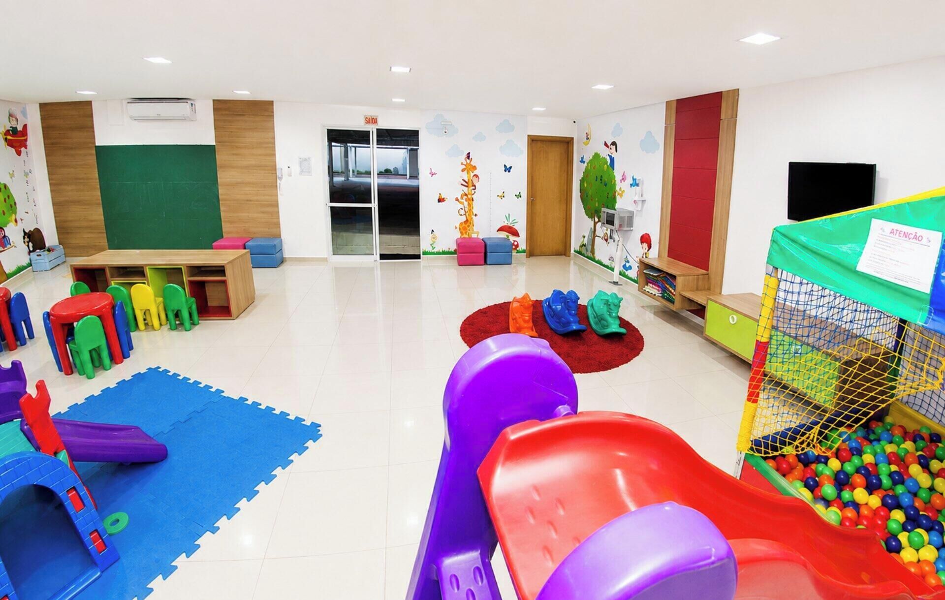 A children's play area with colorful play structures, a ball pit, and a slide.