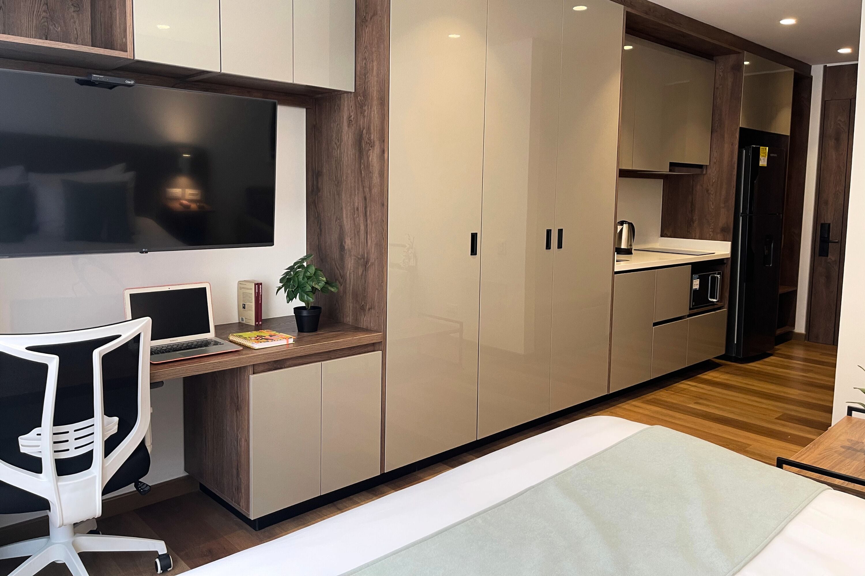 A modern kitchen with a built-in stove, a refrigerator, and a countertop.