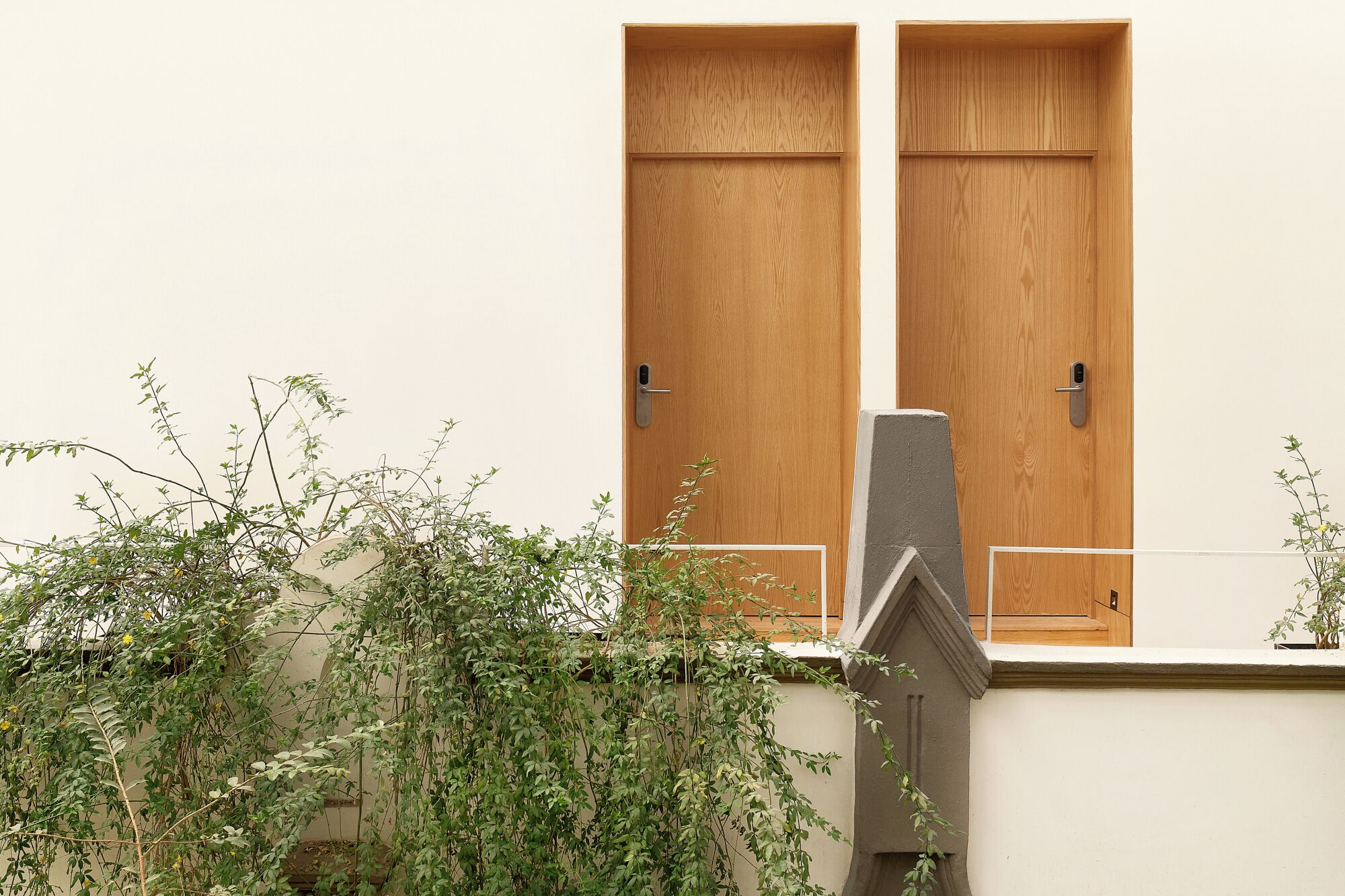 A building with two wooden doors and a small window.