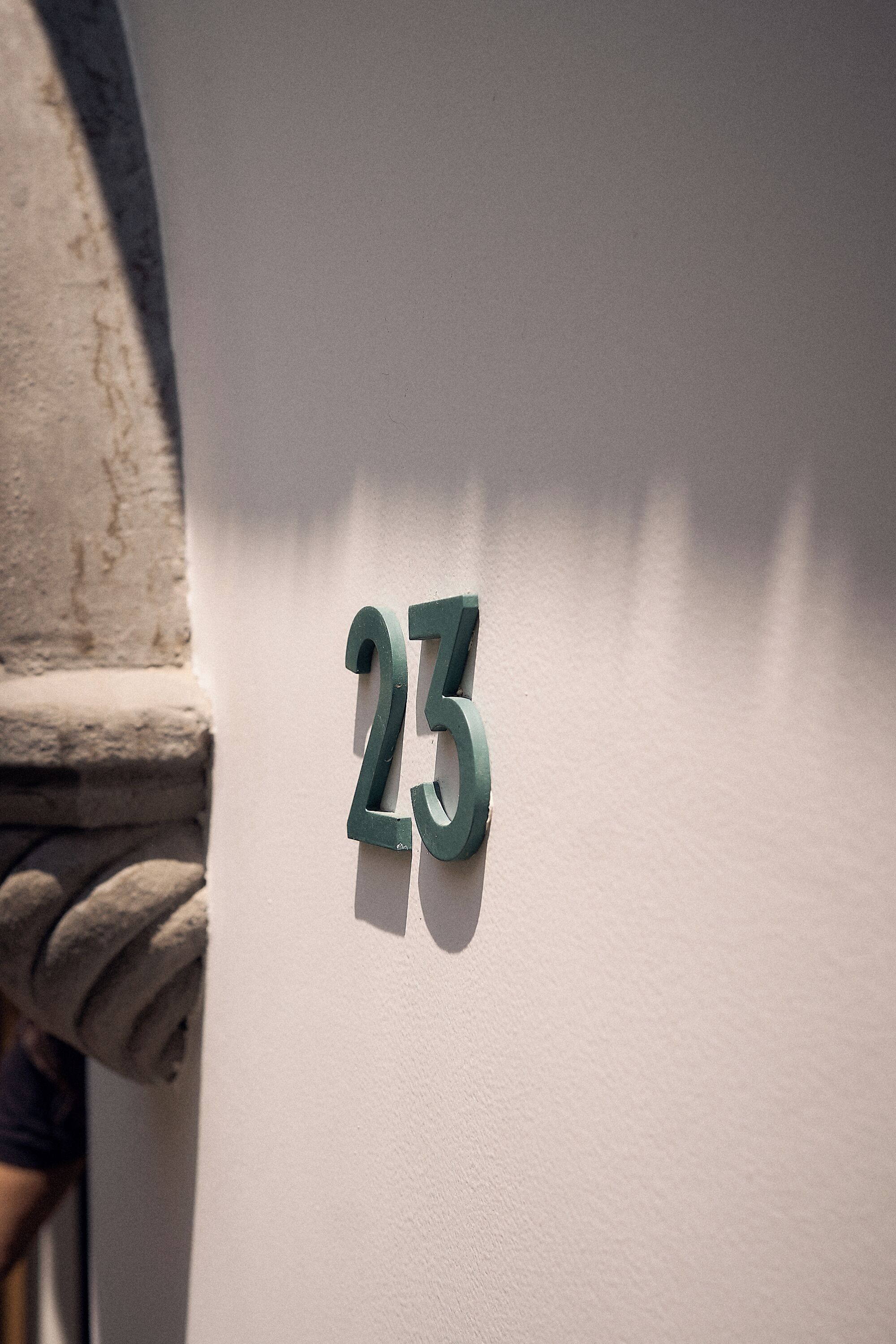 A house number '23' on a white wall.