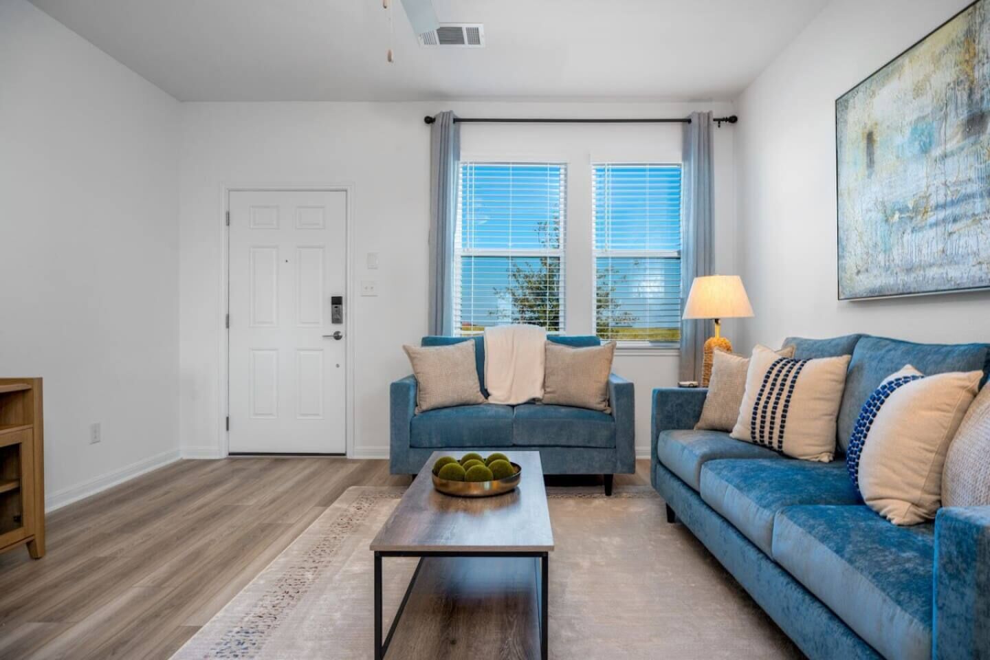 A living room with two sofas, a coffee table, and a lamp.