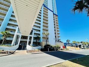 A multi-story hotel with a modern design, featuring balconies and a central atrium. - Seychelles! Beach Front! 2BED 2BATH-NEXT TO SCHOONER'S! FREE BEACH CHAIRS!  (Panama City Beach)