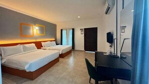 A hotel room with two beds, a desk, and a TV. - Dreamz Village (Langkawi)