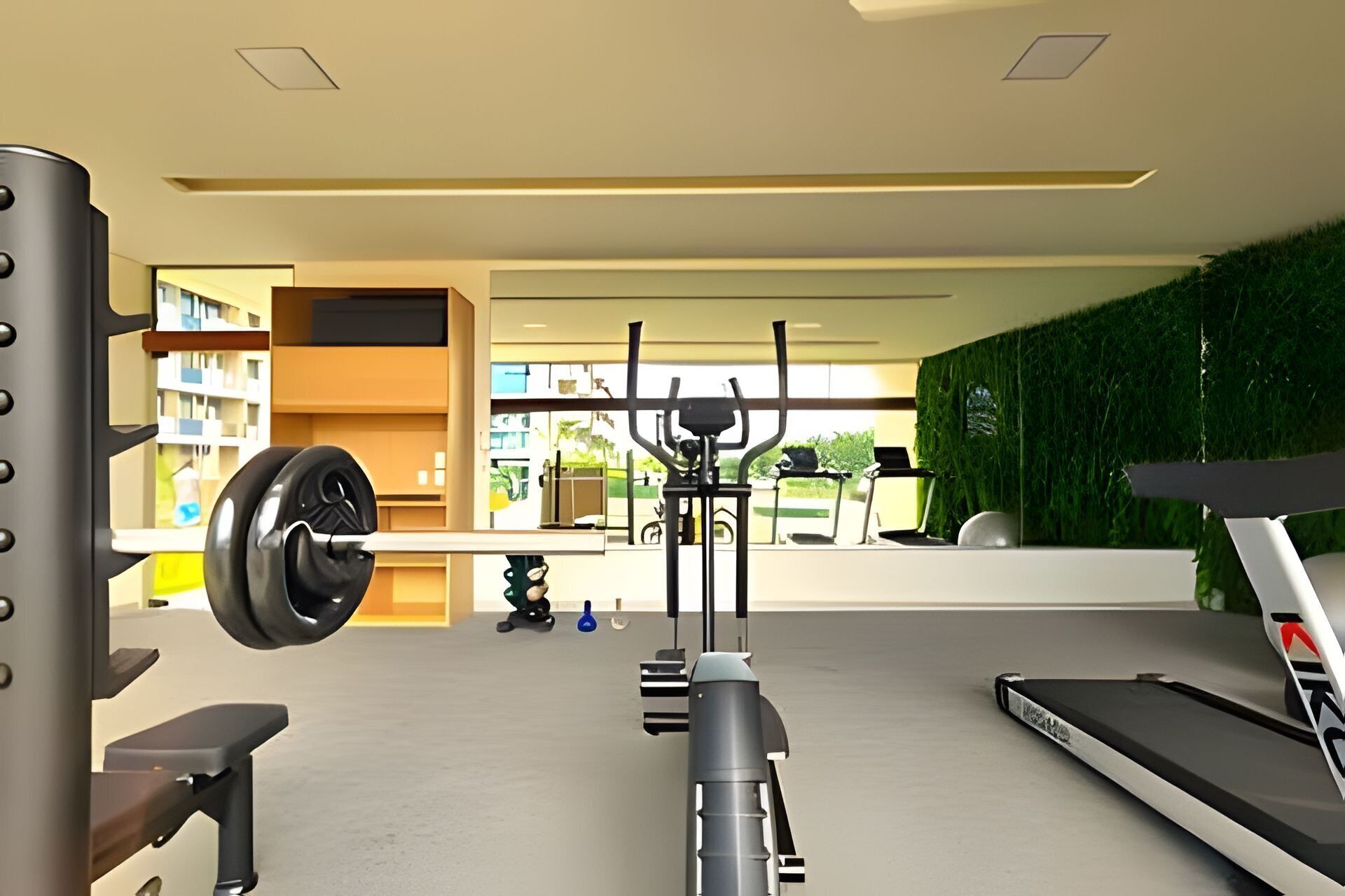 A gym with a treadmill, weight bench, and various exercise equipment.