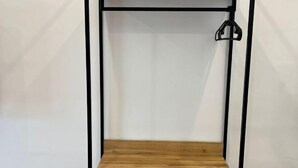 A wooden shelf with a black metal frame and a hook on the right side. - Raintown Cottage (Tupai)