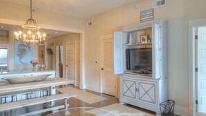 A spacious kitchen with a central island, a chandelier, and a built-in microwave. - Smurf Mountain by Avantstay Private Beach + Pool Redfish Village (Santa Rosa Beach)