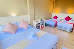 A hotel room with a large bed, two smaller beds, a desk, and a chair. - DJ Citi Inn Premier (Kuala Terengganu)