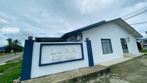 A guest house named 'LUNA' with a signboard, a single-story structure, and a small front porch. - Luna Guesthouse (Semporna)