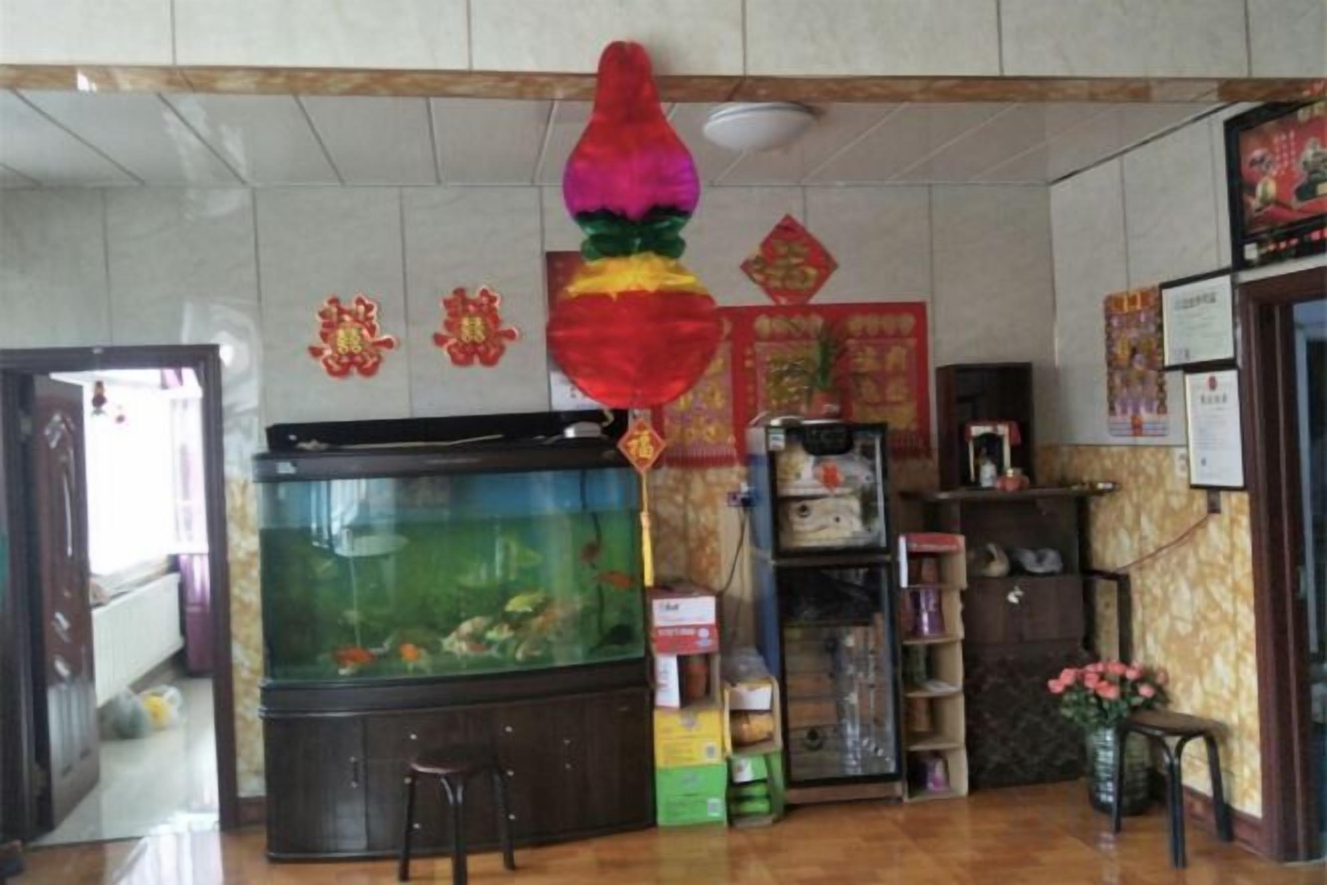 A room with a large fish tank, a reception desk, and various decorations.