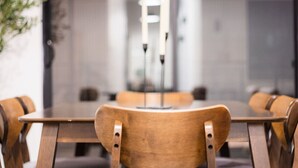 A conference room with a long table and wooden chairs. - Urban Oasis | Pool & Gym | Close to Downtown Fun! (Greenville)
