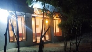 A modern building with large windows and a glass facade, surrounded by trees. - Serene villa on Wasini island, mkwiro village pet friendly  (Kwale County)
