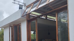 A modern house with large sliding glass doors leading to a covered outdoor area. - Serene villa on Wasini island, mkwiro village pet friendly  (Kwale County)