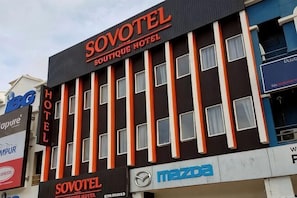 A hotel building with a sign reading 'SOVOTEL BOUTIQUE HOTEL' and a Mazda dealership sign below. - Sovotel Boutique Hotel @ Puchong (Puchong)