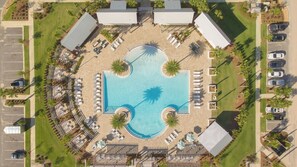 An aerial view of a resort with a central swimming pool, lounge areas, and parking. - The Sea And Me by Avantstay Heated Pool (Santa Rosa Beach)