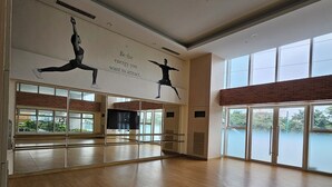 A spacious dance studio with wooden floors, large windows, and motivational wall art. - Luxury condo with gym,WiFi,NETFLIX at Park Mckinley West, Venice, SM Aura BGC (Taguig)