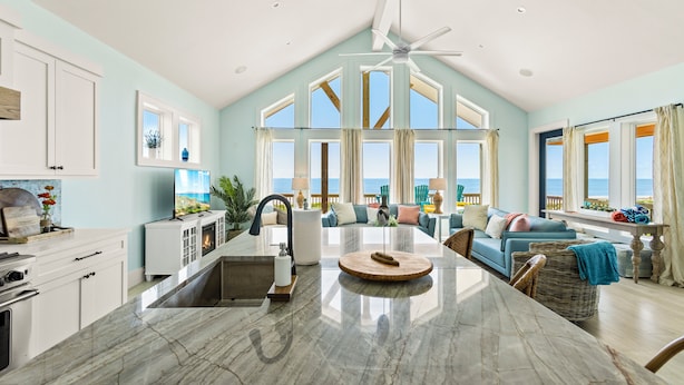 A spacious kitchen with a large island, a dining area, and a view of the ocean. - Luxurious Beachfront 4BR with Pool, Hot tub, Elevator (Port Bolivar)