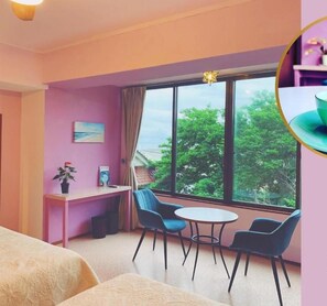 A cozy room with a large window, a desk, two chairs, and a bed. - Hotel MOANA (Oshima)