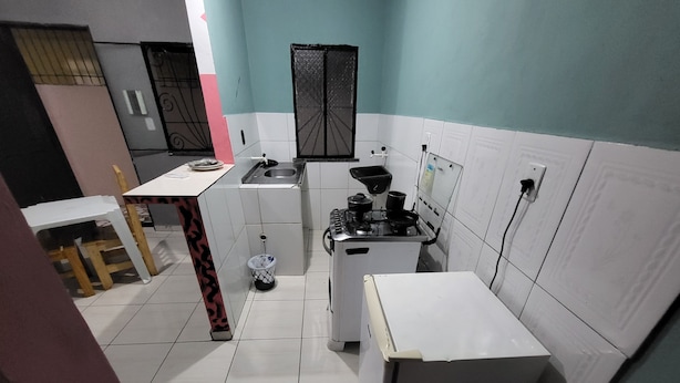 A compact kitchen with white cabinets, a gas stove, and a sink.