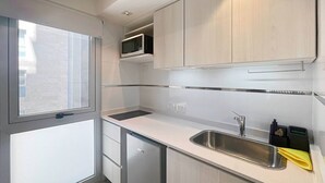 A modern kitchen with a stainless steel sink, a microwave, and a dishwasher. - Luxury In Best Area San Telmo (Buenos Aires)