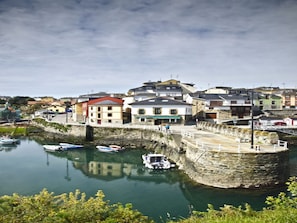 A coastal town with stone buildings, a harbor with boats, and a stone wall. - Room-welcoming Double Room With Private (Valdes)