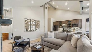 A modern living room with a sectional sofa, a small round coffee table, and a chair.