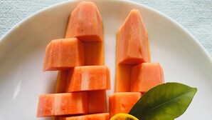 A white plate with neatly arranged cubed sweet potatoes and a lemon slice with a leaf garnish. - Suzuki's Lagoon Front (Katunayaka)