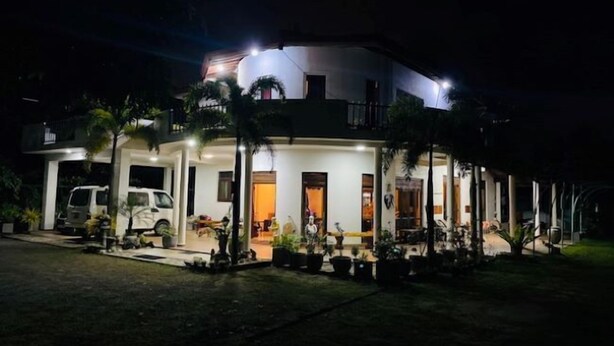 A two-story house with a balcony, a driveway, and several potted plants. - Suzuki's Lagoon Front (Katunayaka)