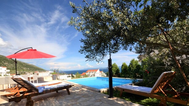 A poolside area with lounge chairs and a red umbrella, overlooking a swimming pool and a scenic view of buildings and hills. - Marvelous Escape Bol Island Villa With Pool (Bol)