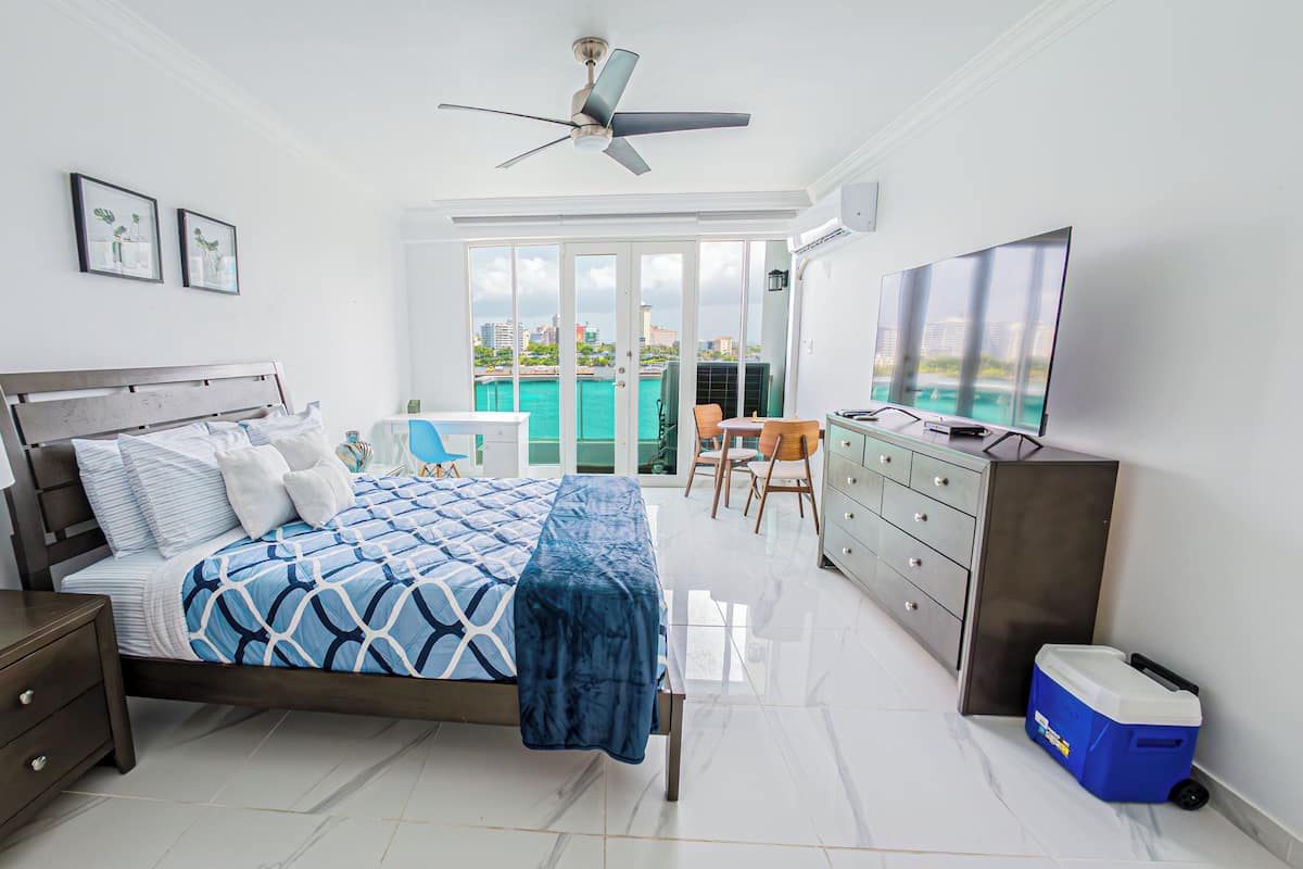 Exclusive Studio Suite, Balcony, Lagoon View | Desk, laptop workspace, blackout curtains, iron/ironing board