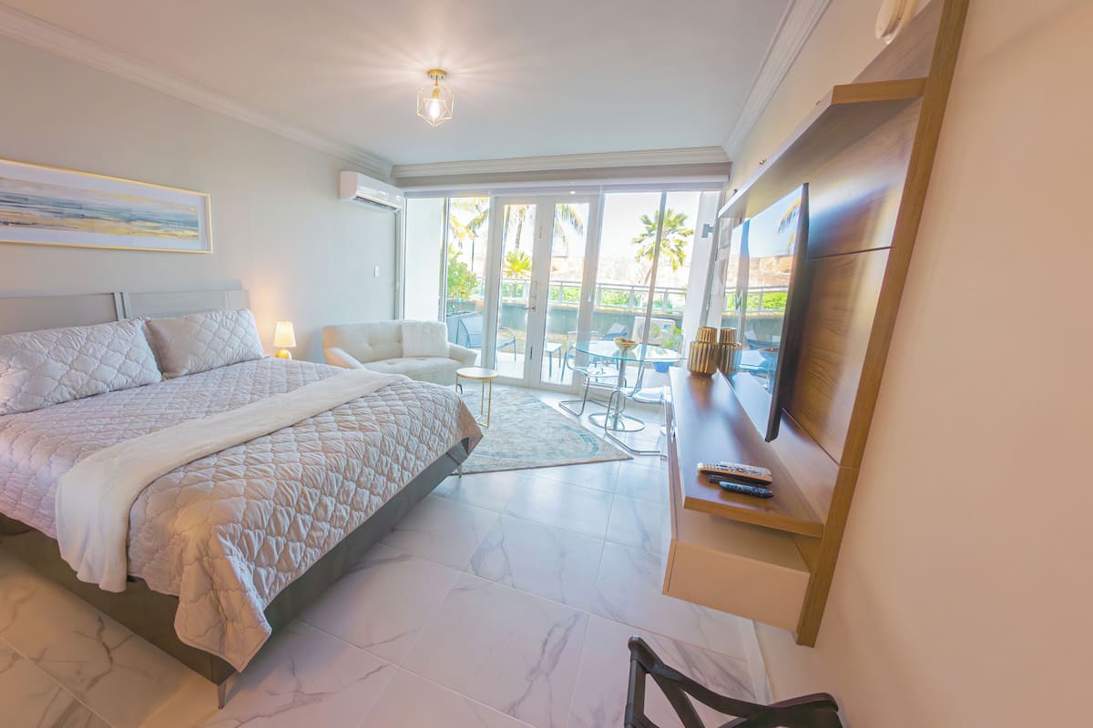 Exclusive Studio Suite, Balcony, Lagoon View | Desk, laptop workspace, blackout curtains, iron/ironing board
