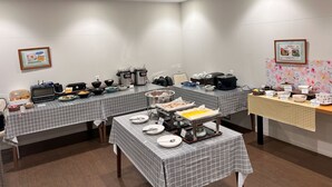 A conference room with tables set for a meeting, equipped with electronic devices, and various food and beverage stations. - Hotel Kurume Hills (Kurume)