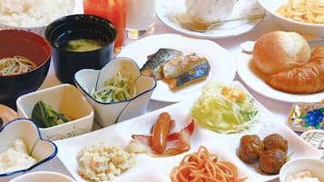 A variety of dishes including noodles, fish, croissants, and meatballs, suggesting a diverse meal selection.