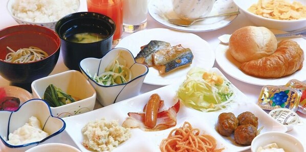 A variety of dishes including noodles, fish, croissants, and meatballs, suggesting a diverse meal selection. - Hotel Kurume Hills (Kurume)
