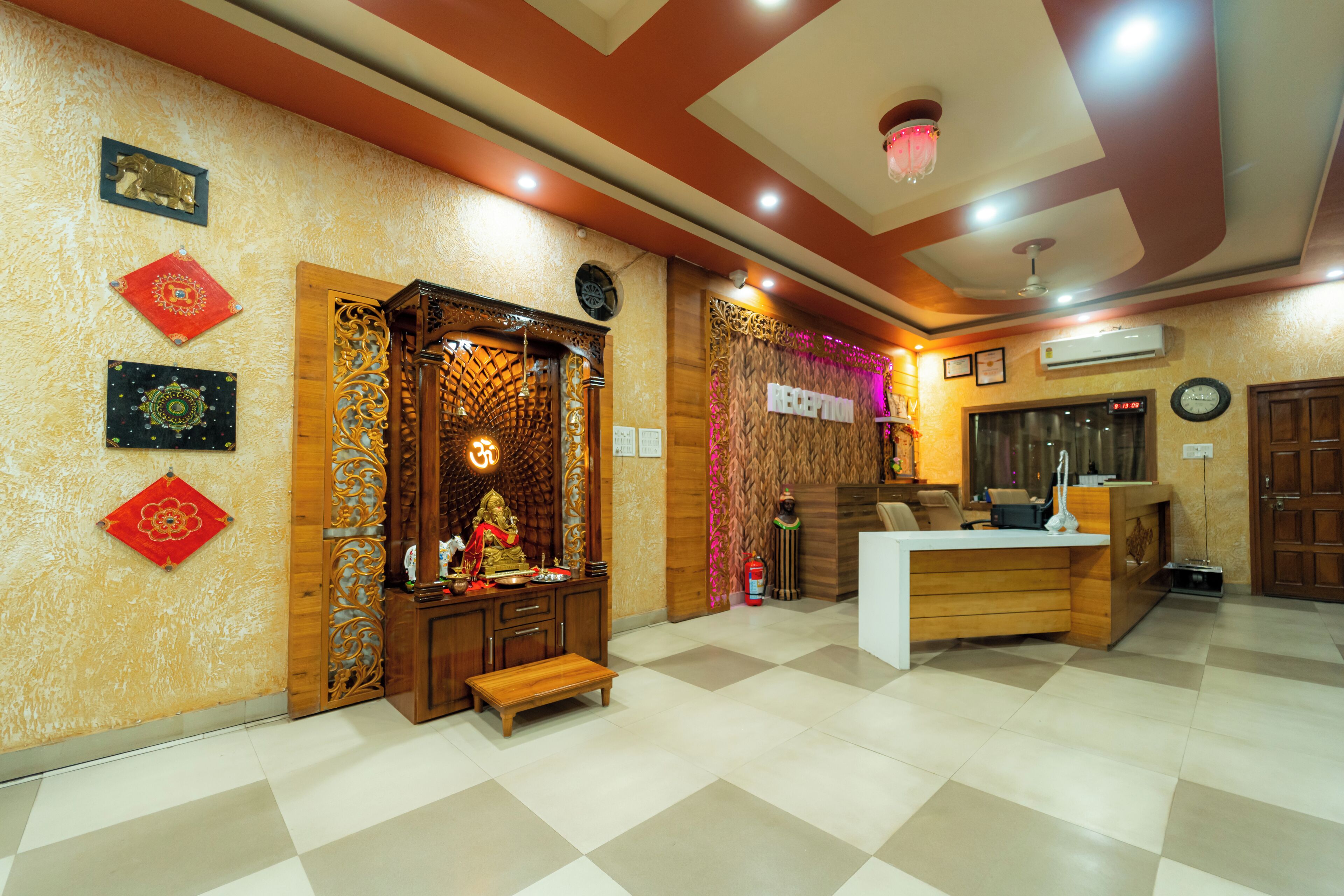 A reception area with a wooden desk, a small shrine, and a checkered floor.