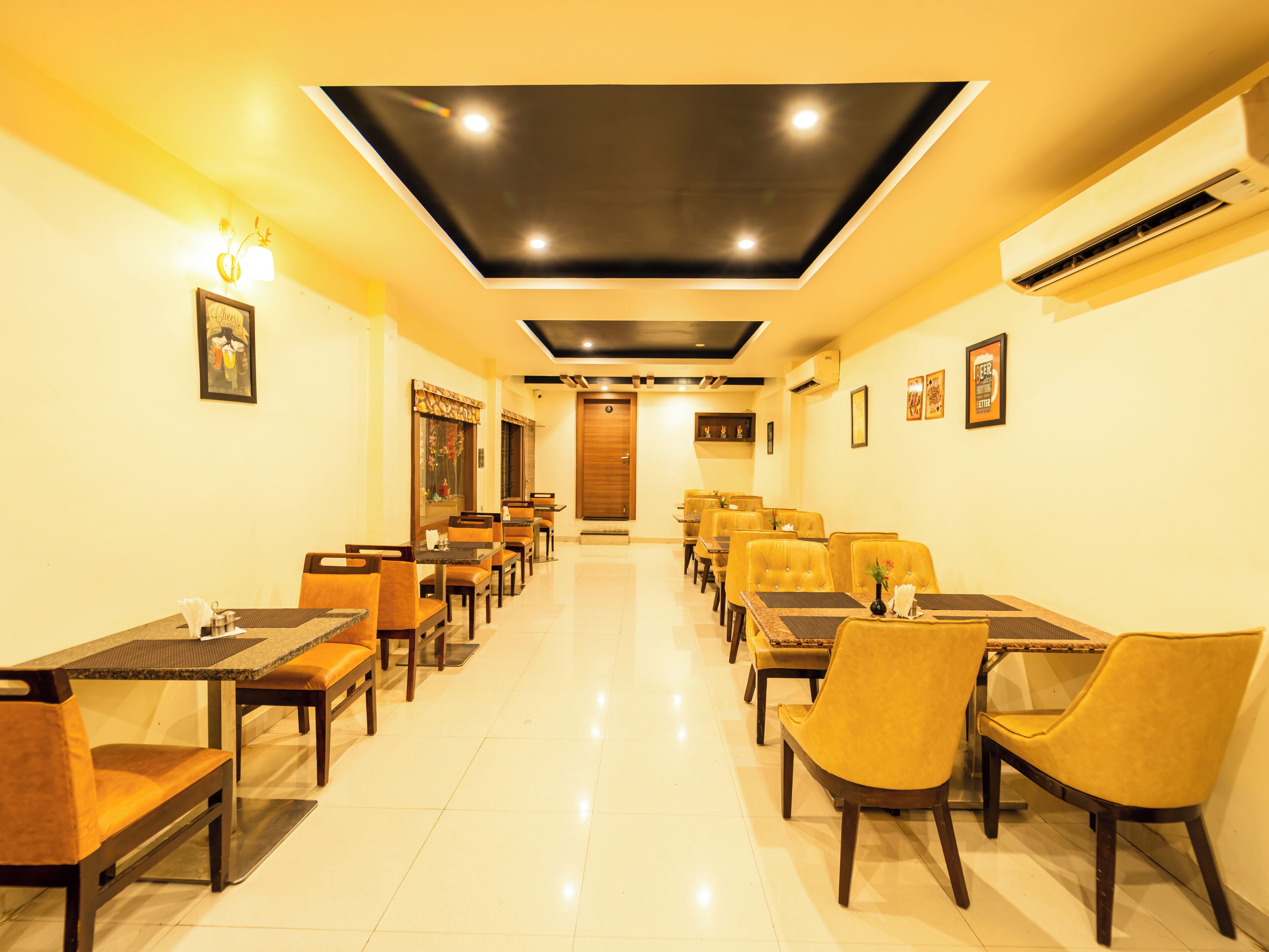 A restaurant with a long counter and multiple tables and chairs.