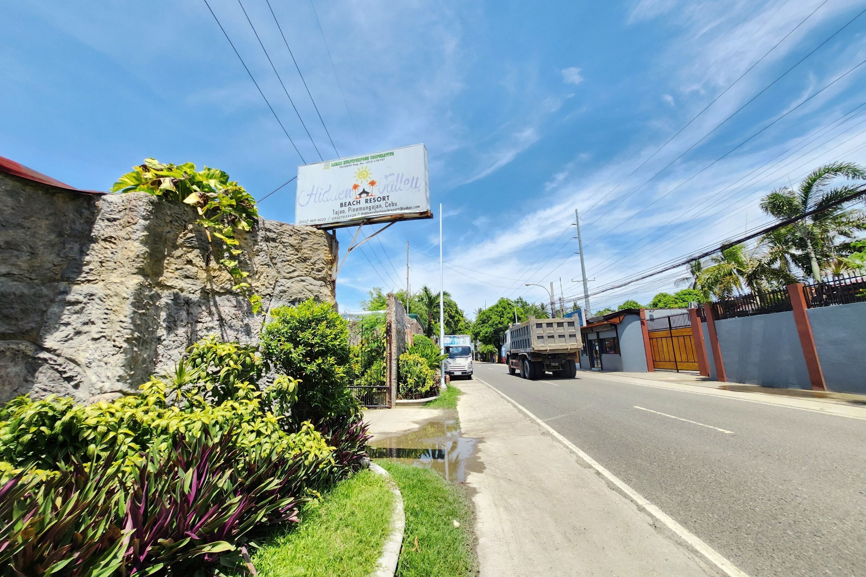 A roadside view of a building with a sign for Hidden Valley Beach Resort.