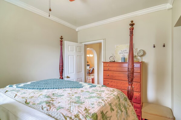 A bedroom with a bed, a wooden dresser, and a door leading to another room. - 1 Mi to KFC Museum: Corbin Getaway! (Corbin)