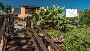 A wooden staircase leading to a building with a sign reading "SEA VILLAS RECEPTION".