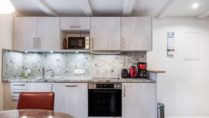 A compact kitchen with a microwave, coffee maker, and dishwasher.