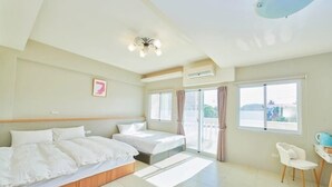 Ein Hotelzimmer mit zwei Betten, einem Schreibtisch und einem Stuhl.