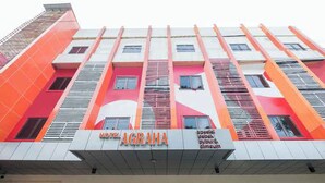 A hotel with a modern facade, featuring a prominent sign that reads "HOTEL AGRAHA." - Hotel O Marina Andalas (Makassar)