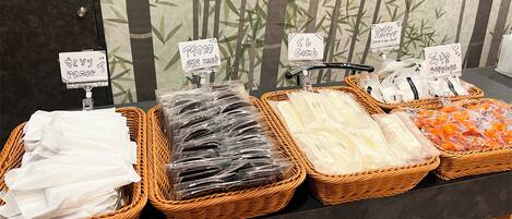 A display of various personal care items in wicker baskets with labels.
