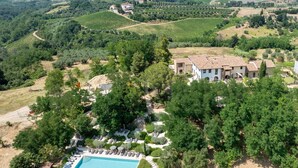 An aerial view of a villa surrounded by vineyards, with a swimming pool and outdoor seating area. - Lovely apartment with pool, A/C, WIFI, TV, veranda and panoramic view, close to San Gimignano (Montaione)