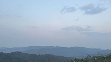 A panoramic view of a mountainous landscape with scattered buildings.