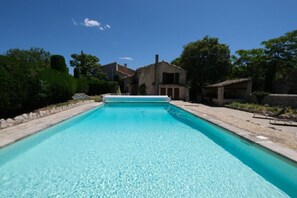 A rectangular swimming pool with clear blue water, surrounded by a stone deck and a stone wall. - Vacation rental house with pool MOURIES LS1-361 (Mouriès)